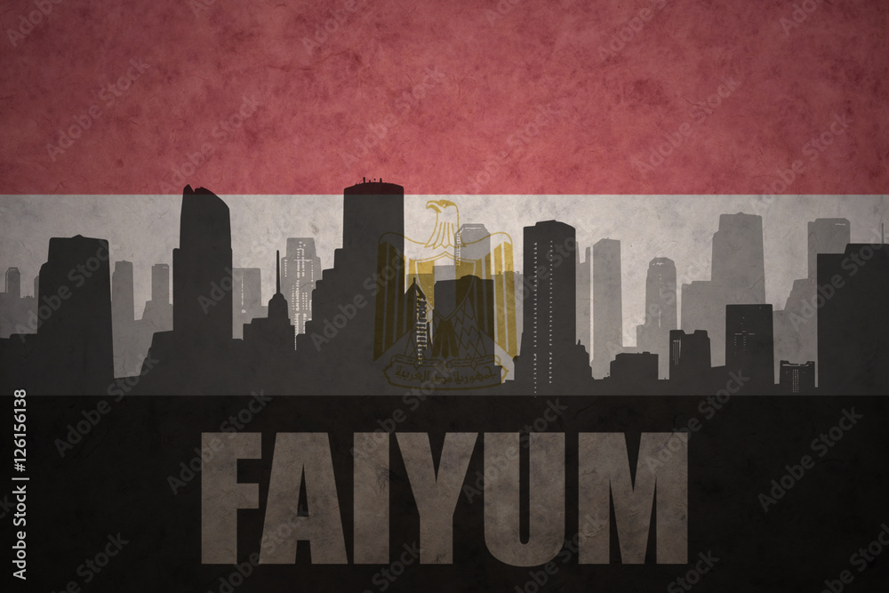 abstract silhouette of the city with text Faiyum at the vintage egyptian flag