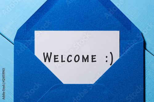 Welcome inscription. Hand drawn letter in blue envelope