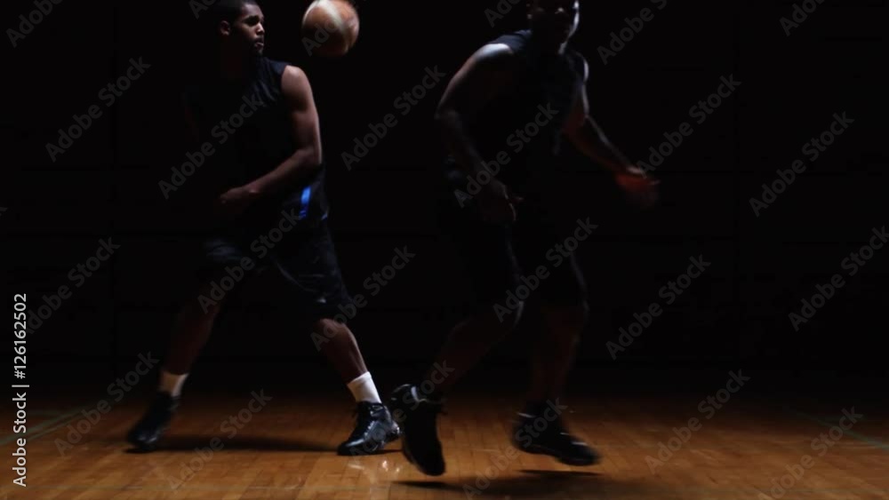 Basketball player fakes out a defender with a fake pass move Basketball player fakes out a defender with a fake pass move