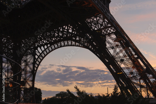 Purple sunset behind base of Eiffel Tower