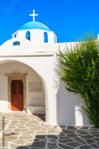 White church with blue dome in Parikia town on Paros island, Greece