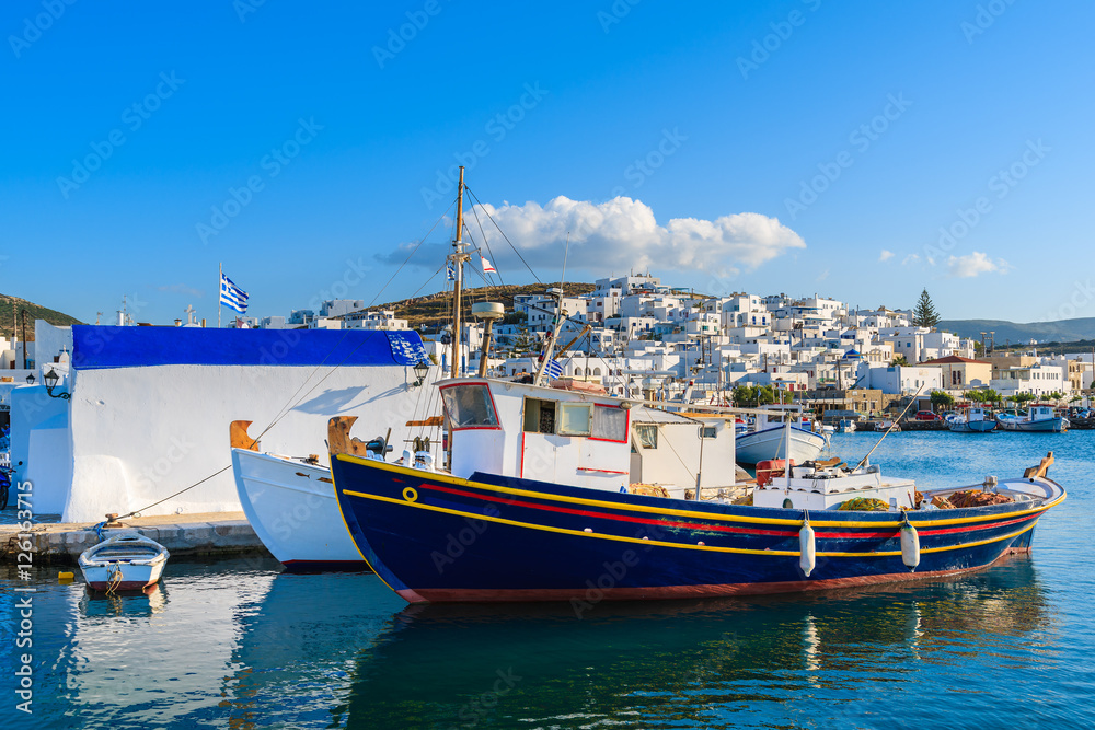 Traditional Greek fishing boats in Naoussa port at sunset time, Paros island, Greece