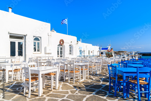 White and blue taverna tables on square in Naoussa port, Paros island, Greece