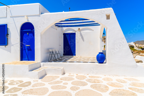 Traditional white house with blue doors in Naoussa town on Paros island, Greece