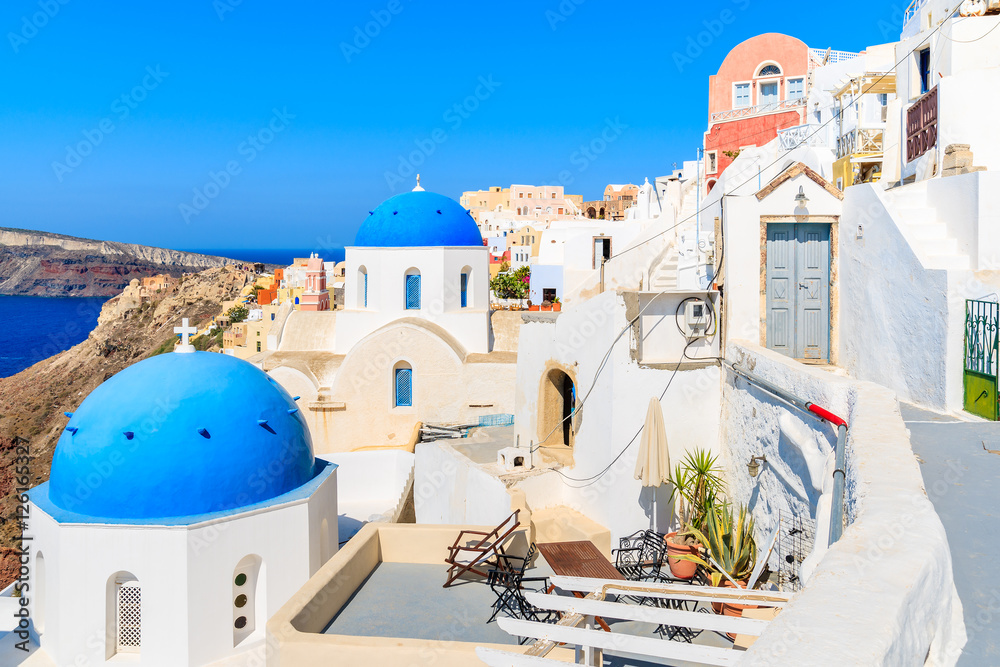 Famous blue domes of white churches in Oia village on Santorini island, Greece