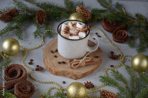 conceptual composition on a wooden table with a cup of coffee, marshmallow and Christmas decorations. Happy New Year or Christmas background.