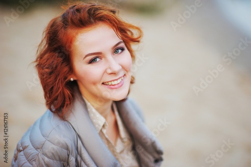 A wonderful portrait of a young pretty girl with beautiful eyes and charming smile, outdoor, closeup.