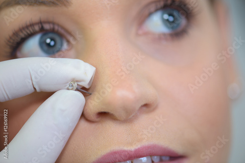 girl getting a piercing