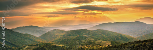 Colorful mountain sunset panorama. Autumn alpine scene