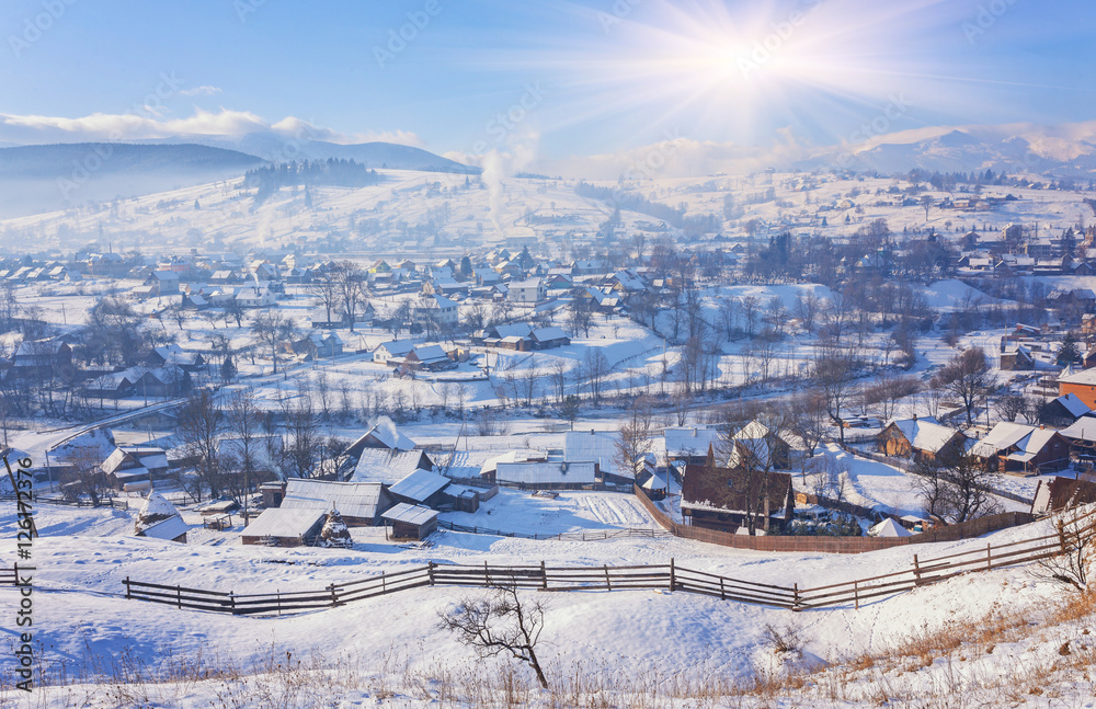 Winter fairytale, snowfall covered the trees and houses in the m