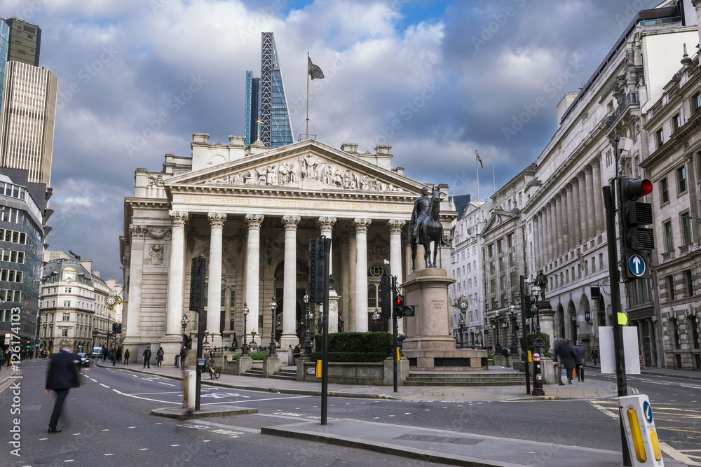 London, England - The Royal Exchange building with walking business man