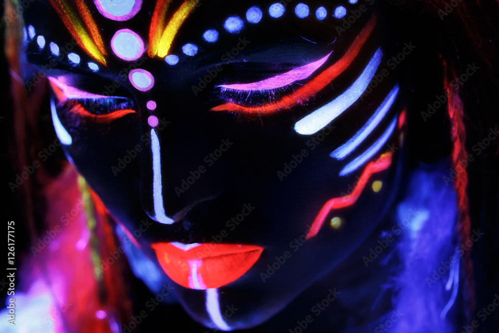 Woman with a neon makeup in ultraviolet light Woman with a neon makeup in ultraviolet light