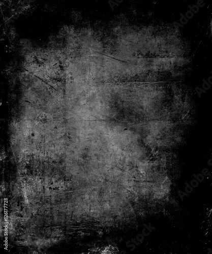 Scary abstract vintage grunge background with faded central area for your text or picture, scratched halloween black background