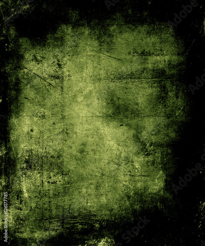Scary abstract vintage grunge background with faded central area for your text or picture, scratched halloween green background