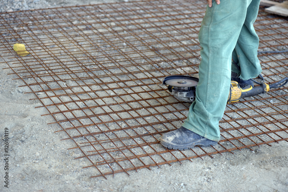 Construction worker assembling iron frame Construction worker assembling iron frame