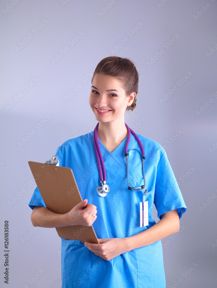 Woman doctor standing with folder at hospital Woman doctor standing with folder at hospital