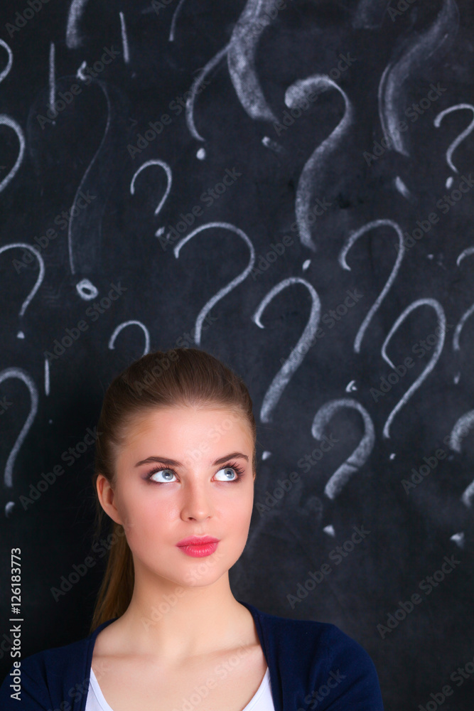 Young girl with question mark on a gray background Young girl with question mark on a gray background