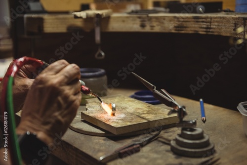 Hands of craftswoman using blow torch