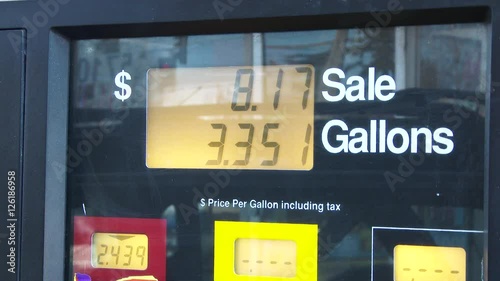 Time lapse video at gas station pump filling up, close up on price per gallon as fuel pumps.