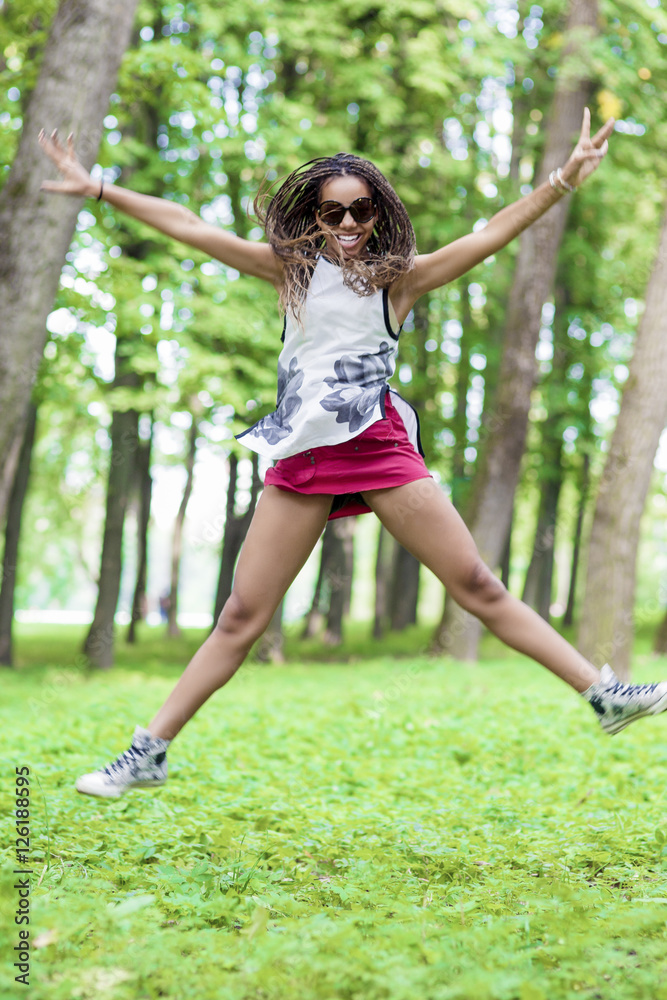African American Teenager Girl with Hands Outstretched Jumping with Hands Outstretched