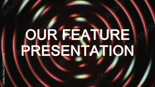 The text Our feature presentation appears over a set of spinning circles with a lens flare at the beginning. Grindhouse low-budget b-movie style.
