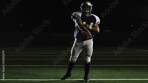 Isolated quarterback throws the ball down the field in front of the camera