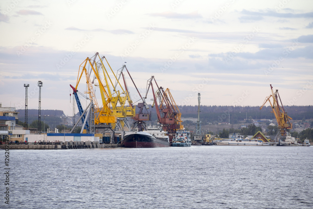 River cargo port cranes on the quayside