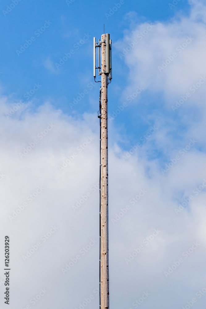Dipole antenna for telecommunications with blue sky background. Dipole antenna for telecommunications with blue sky background.