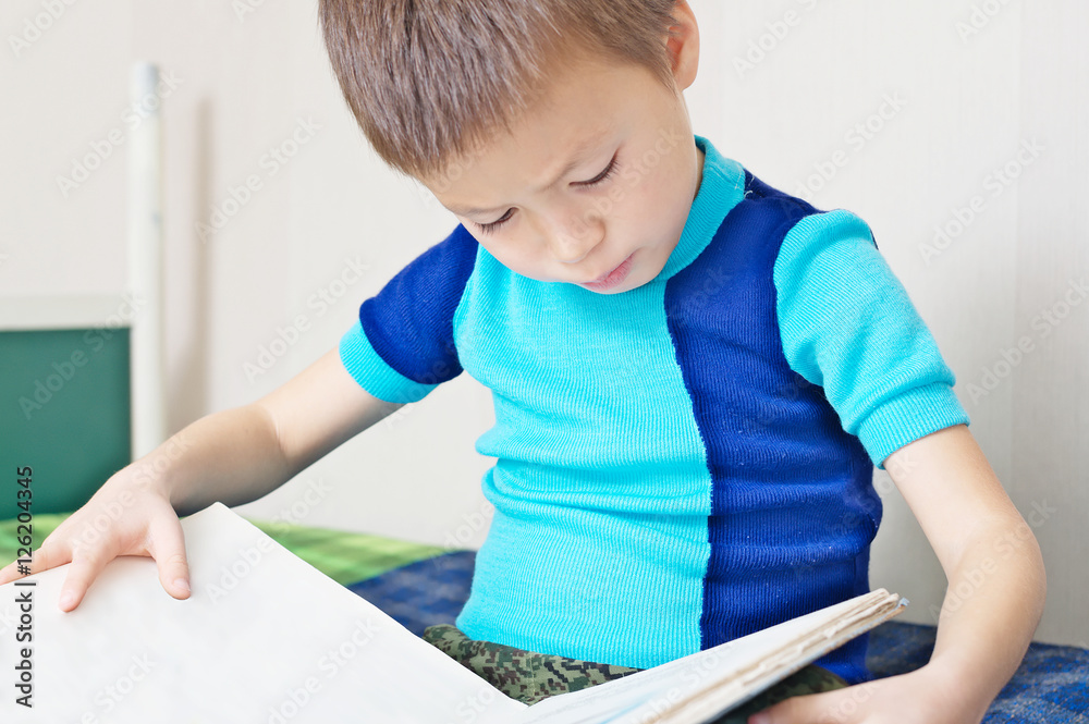 Child reading book on bed oneself learning read Child reading book on bed oneself learning read