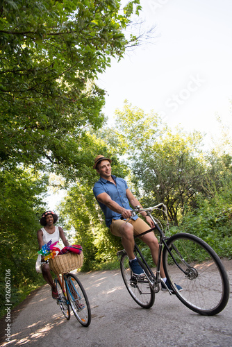 Young couple having joyful bike ride in nature