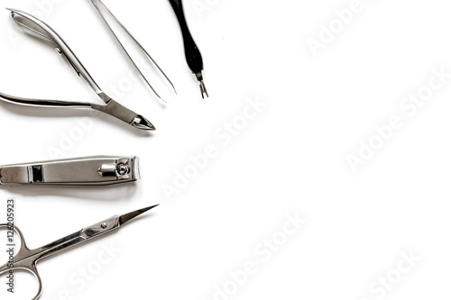 Tools of a manicure set on white background top view
