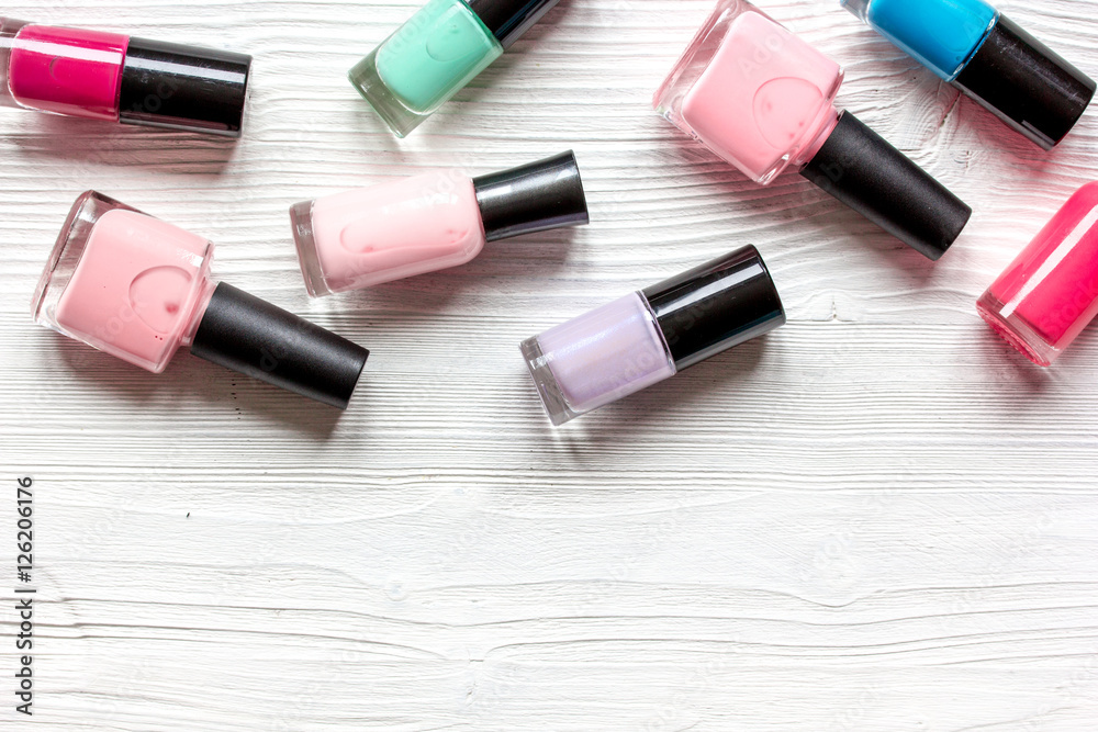 lot of bottles nail polish on wooden background top view lot of bottles nail polish on wooden background top view