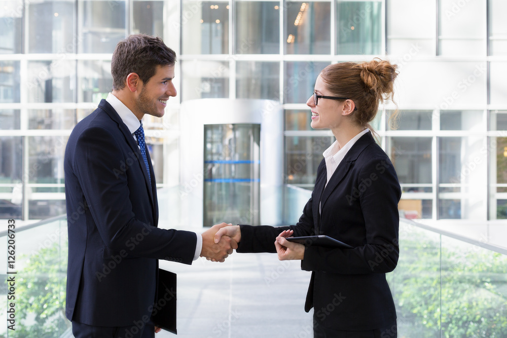 Two young business people shaking hands Two young business people shaking hands