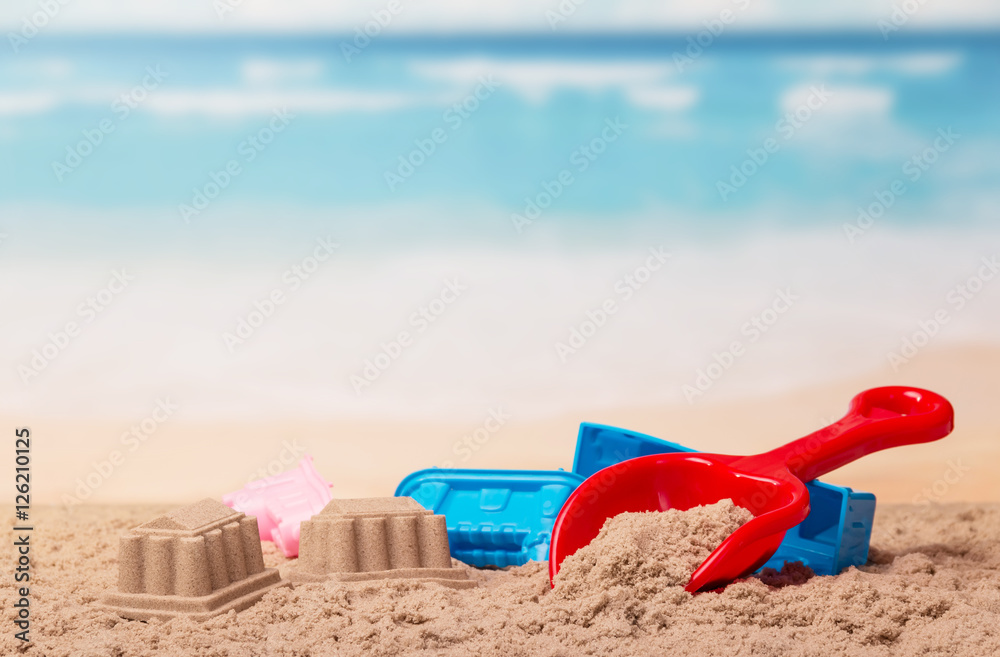 Bright children's toys in the sand against sea. Bright children's toys in the sand against sea.