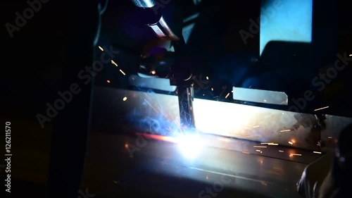 Welding robots movement in a car factory  welding splashes brews argon