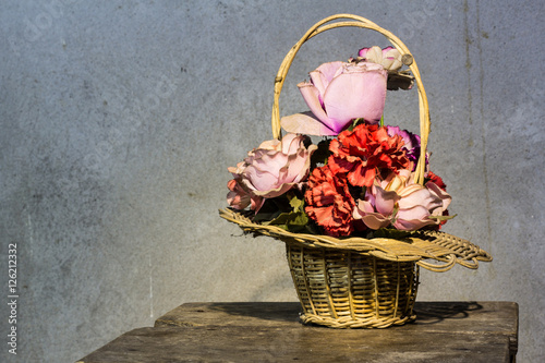 rose plastic in basket still life photo