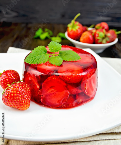 Jelly strawberry with mint and berries on dark board