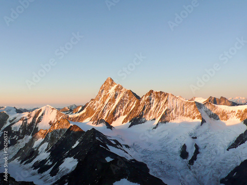 a view of the Finsteraarhorn in the Swiss Alps at sunrise