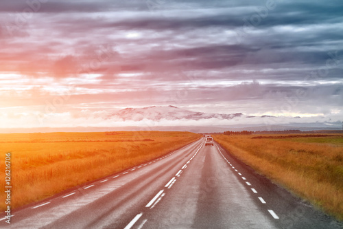 Empty road leading to snow covered mountains  Beautiful landscape in early autumn of Iceland