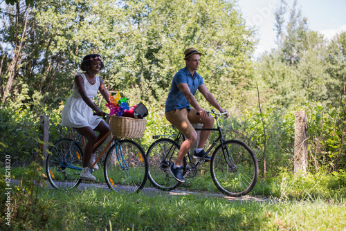 Young couple having joyful bike ride in nature
