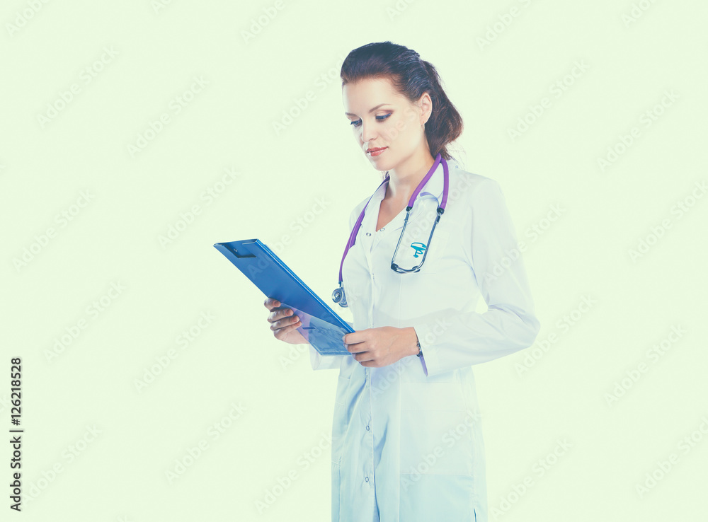 Smiling female doctor with a folder in uniform standing at hospital Smiling female doctor with a folder in uniform standing at hospital