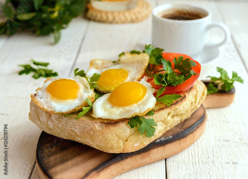 Bruschetta with quail egg, bell pepper, herbs and a cup of coffe