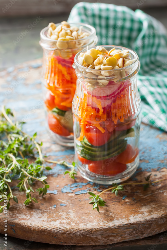 vegetable germinated lentil salad in a jar on a board, selective focus vegetable germinated lentil salad in a jar on a board, selective focus