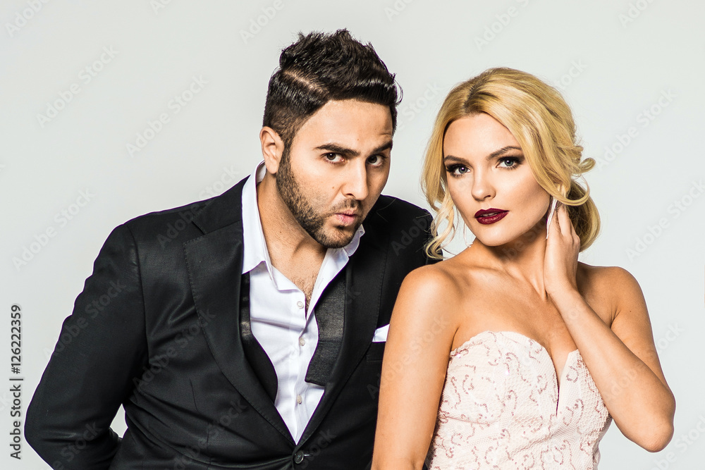 young fashion couple on a white background in studio