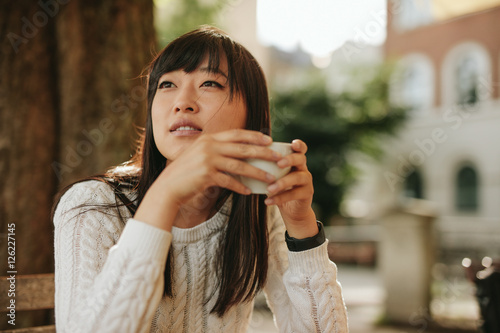 Photography Beautiful young chinese woman having coffee at cafe