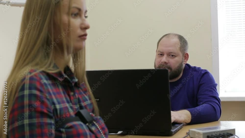 Lie-detector test, a woman answers the questions of the expert Lie-detector test, a woman answers the questions of the expert