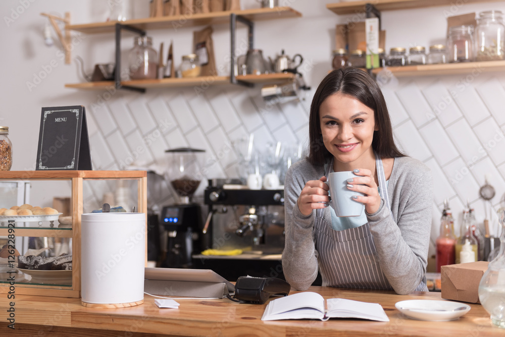 Attractive joyful woman having a coffee break. Attractive joyful woman having a coffee break.
