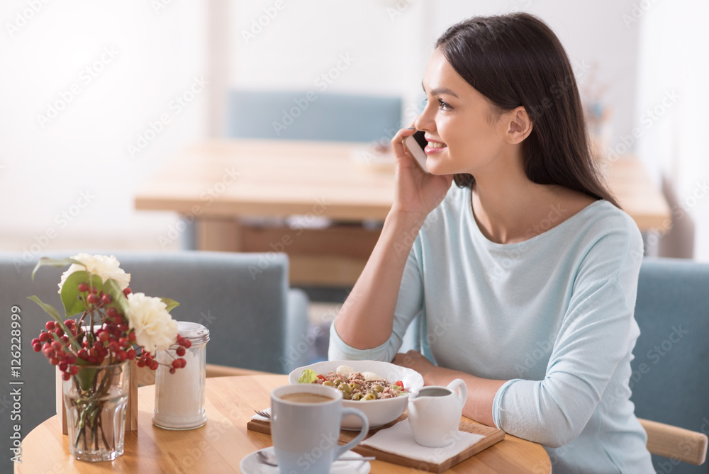 Attractive young woman having lunch in a cafe. Attractive young woman having lunch in a cafe.