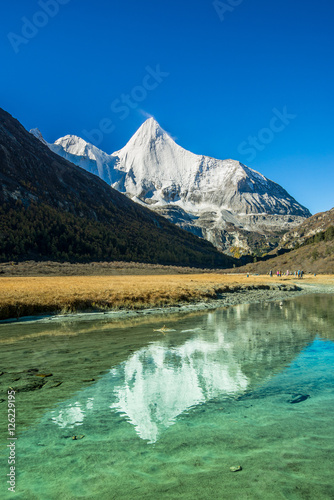 Reflection of the holy snow mountain at Yading national level reserve in Daocheng County, in the southwest of Sichuan Province, China.