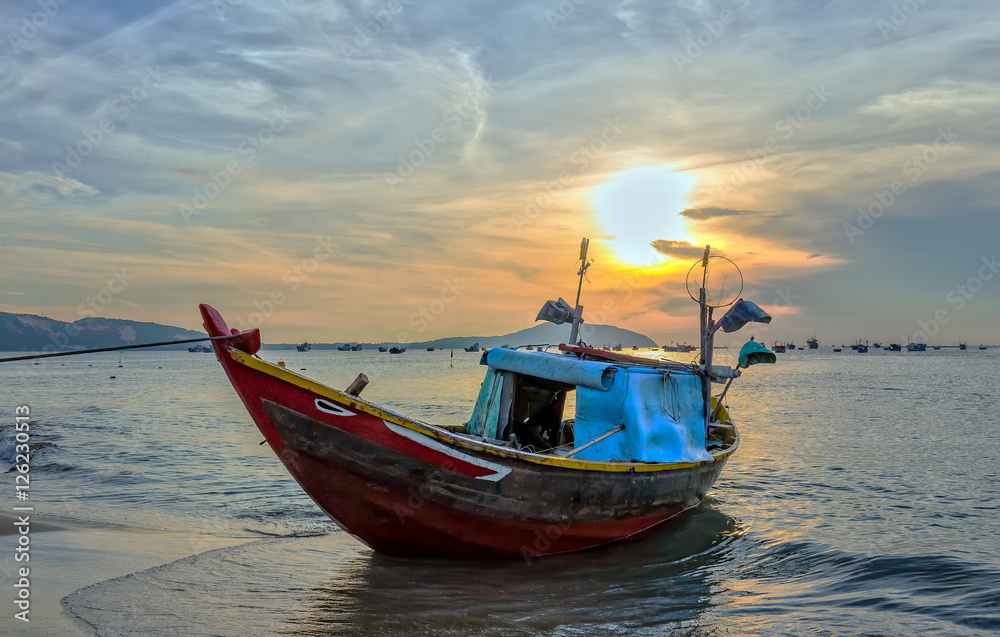 Fishing boat before dawn as the sun slowly rise to express the rest of the season when fishermen fish on, languish waiting to be put to sea Fishing boat before dawn as the sun slowly rise to express the rest of the season when fishermen fish on, languish waiting to be put to sea